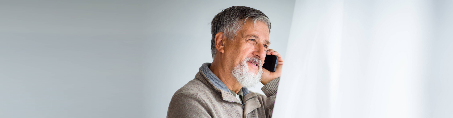 elderly man using his phone